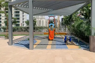 a playground with a slide in a park at Frank Porter - 17 Icon Bay in Dubai