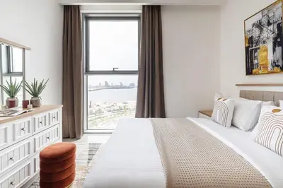 a bedroom with a bed with a large window at Frank Porter - 17 Icon Bay in Dubai