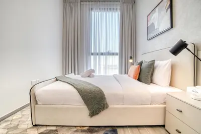 a bedroom with a large bed with a window at Alluring 2BR with Assistant Room at Mesk 1 Midtown Dubai Production City by Deluxe Holiday Homes in Dubai