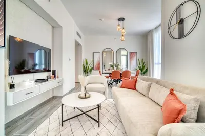 a living room with a couch and a table at Alluring 2BR with Assistant Room at Mesk 1 Midtown Dubai Production City by Deluxe Holiday Homes in Dubai