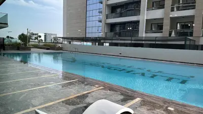 a large swimming pool in front of a building at LUXURY 2 bedrooms 5 minutes from Burj Khalifa in Dubai