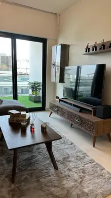 a living room with a large television and a table at LUXURY 2 bedrooms 5 minutes from Burj Khalifa in Dubai
