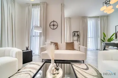 a living room with a white couch and a table at Harmonious 2BR with Assistant Room at Mesk 1 Midtown Dubai Production City by Deluxe Holiday Homes in Dubai