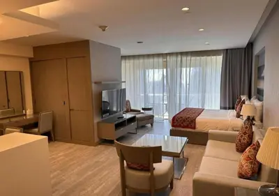 a hotel room with a bed and a living room at Fashion Avenue - Dubai Mall in Dubai