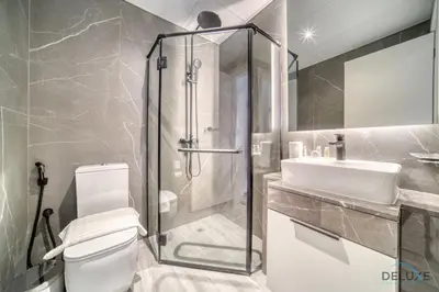 a bathroom with a shower and a toilet and a sink at Idyllic 2BR with Assistant Room at Mesk 1 Midtown Dubai Production City by Deluxe Holiday Homes in Dubai