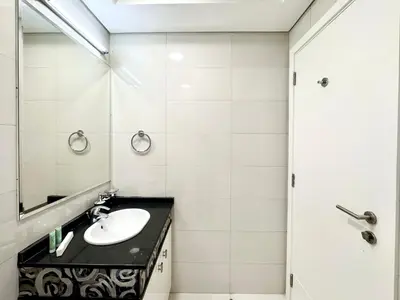a bathroom with a sink and a mirror at Royal Maison Deluxe 2 Br in Executive Bay in Dubai