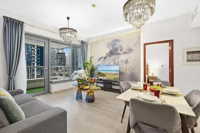 a living room with a couch and a table at 2BR Burj View with Balcony, Pool, Gym & Walk to Dubai Mall in Dubai