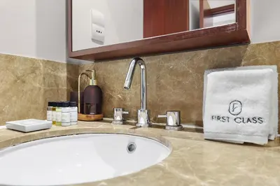 a bathroom sink with a first glass towel on a counter at 2BR Burj View with Balcony, Pool, Gym & Walk to Dubai Mall in Dubai