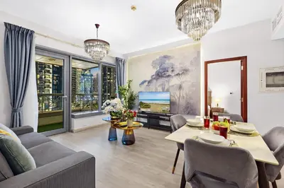 a living room with a couch and a table at 2BR Burj View with Balcony, Pool, Gym & Walk to Dubai Mall in Dubai
