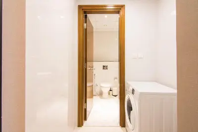 a bathroom with a toilet and a washing machine at Stunning 1BR AL Habtoor City -Meera Tower 1108 in Dubai
