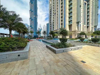 a city street with tall buildings and palm trees at Stunning 1BR AL Habtoor City -Meera Tower 1108 in Dubai