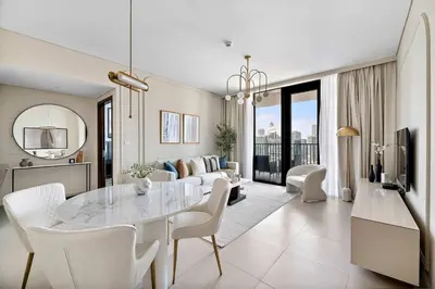 a white living room with a table and a couch at Silkhaus elegant and luxury 1BDR Downtown in Dubai
