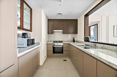 a kitchen with a sink and a microwave at Silkhaus elegant and luxury 1BDR Downtown in Dubai