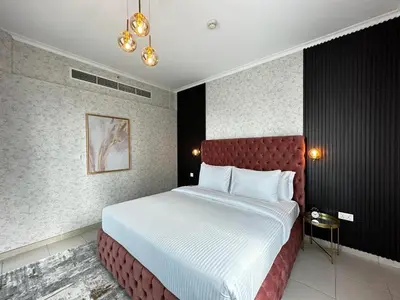 a bedroom with a large bed with a red headboard at Durrani Homes - Grand 5BR besides Burj khalifa and Fountain view in Dubai