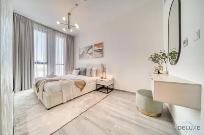 a white bedroom with a bed and a large window at Pleasant 2BR with Assistant Room at Mesk 1 Midtown Dubai Production City by Deluxe Holiday Homes in Dubai