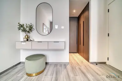 a bathroom with a stool and a mirror at Pleasant 2BR with Assistant Room at Mesk 1 Midtown Dubai Production City by Deluxe Holiday Homes in Dubai