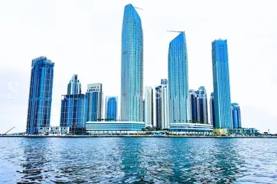 a view of a city from the water with buildings at The Shrashi Suites, Dubai Creek Harbour - Paradise on the Island with Dubai Skyline & Waterfront View in Dubai