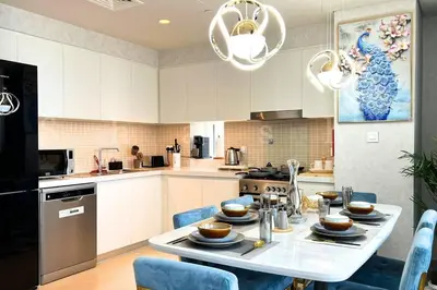 a kitchen with a table with dishes on it at The Shrashi Suites, Dubai Creek Harbour - Paradise on the Island with Dubai Skyline & Waterfront View in Dubai
