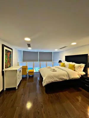 a bedroom with a large bed and a desk at Stunning Duplex Studio in JLT in Dubai