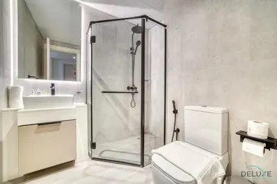 a bathroom with a shower and a toilet and a sink at Splendid Studio at Mesk 1 Midtown Dubai Production City by Deluxe Holiday Homes in Dubai
