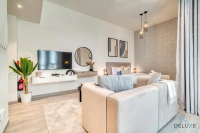 a living room with two beds and a couch at Splendid Studio at Mesk 1 Midtown Dubai Production City by Deluxe Holiday Homes in Dubai