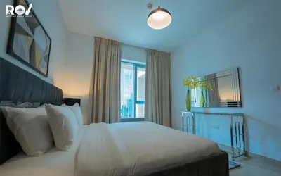 a bedroom with a white bed and a window at Luxury 2 Bedroom Suite with Full Burj Khalifa View in Dubai