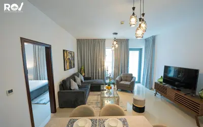 a living room with a couch and a tv at Luxury 2 Bedroom Suite with Full Burj Khalifa View in Dubai