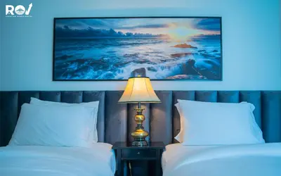 a bedroom with two beds and a lamp and a painting at Luxury 2 Bedroom Suite with Full Burj Khalifa View in Dubai