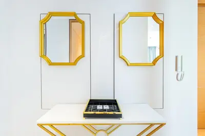 a table with two mirrors and a laptop on it at Address JBR: Beachfront Bliss & Sky-high Luxury in Dubai