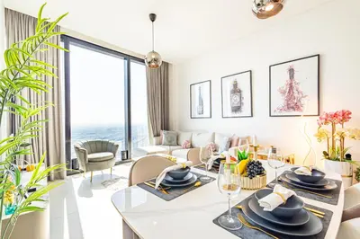 a living room with a table and a couch at Address JBR: Beachfront Bliss & Sky-high Luxury in Dubai
