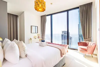 a bedroom with a bed and a large window at Address JBR: Beachfront Bliss & Sky-high Luxury in Dubai