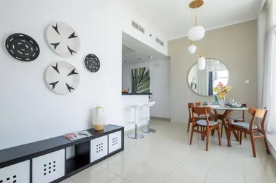 a kitchen and dining room with a table and chairs at Frank Porter - Botanica Tower 1 in Dubai