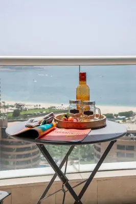 a table with a plate of food on top of a window at Frank Porter - Botanica Tower 1 in Dubai