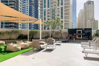 a patio with chairs and tables in a city at Frank Porter - Botanica Tower 1 in Dubai