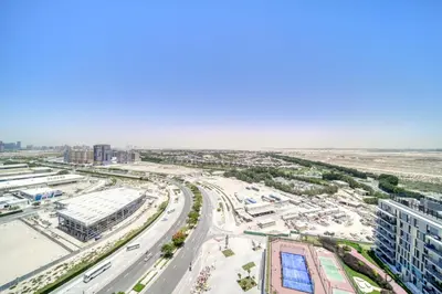 an aerial view of a city with a highway at Enchanting Studio at Mesk 1 Midtown Dubai Production City by Deluxe Holiday Homes in Dubai