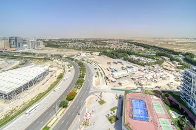 an aerial view of a city with a highway at Upscale Studio at Mesk 1 Midtown Dubai Production City by Deluxe Holiday Homes in Dubai