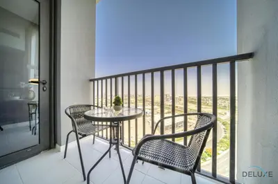 a table and chairs on a balcony with a view at Tasteful Studio at Mesk 1 Midtown Dubai Production City by Deluxe Holiday Homes in Dubai