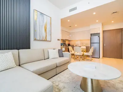 a living room with a couch and a table at Radiant 1BR in Burj Royale - Downtown Dubai in Dubai