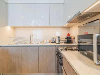 a kitchen with a sink and a stove top oven at Pleasant 1BR in Burj Royale - Downtown Dubai in Dubai
