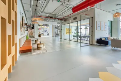 an open office with a lobby with chairs and tables at Sleek Studio at UNA Town Square Dubailand by Deluxe Holiday Homes in Dubai