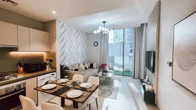 a kitchen and a living room with a table and chairs at STAY BY LATINEM Luxury 1BR Holiday Home CV A103 near Burj Khalifa in Dubai