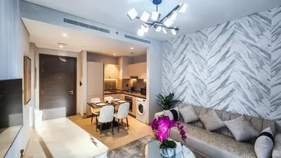 a living room with a couch and a table at STAY BY LATINEM Luxury 1BR Holiday Home CV A103 near Burj Khalifa in Dubai