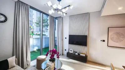 a living room with a glass table and a large window at STAY BY LATINEM Luxury 1BR Holiday Home CV A103 near Burj Khalifa in Dubai