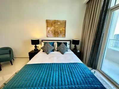 a bedroom with a large bed with a blue blanket at LuxBnB Studio Ghalia J V C in Dubai
