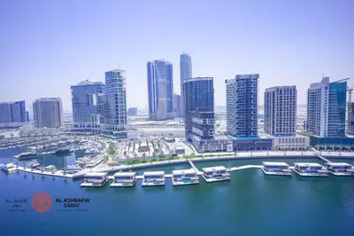 a group of boats docked in a harbor in a city at Alashrafia Saray- Wonderous Studio in Canal Views in Dubai