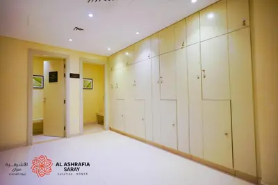 a large room with white lockers in a gym at Alashrafia Saray- Wonderous Studio in Canal Views in Dubai