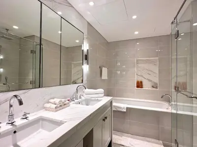 a bathroom with a tub and a sink and a shower at Opera Grand by Luxstay Holiday Homes in Dubai