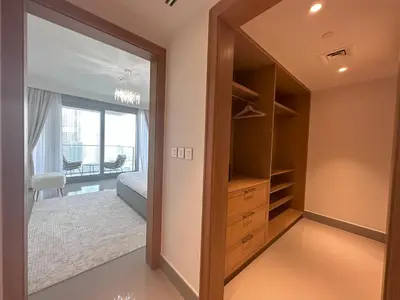 a walk in closet with a door open to a bedroom at Opera Grand by Luxstay Holiday Homes in Dubai