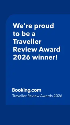 a blue sign that says were proud to be a traveller reviewagency winner at Opera Grand by Luxstay Holiday Homes in Dubai