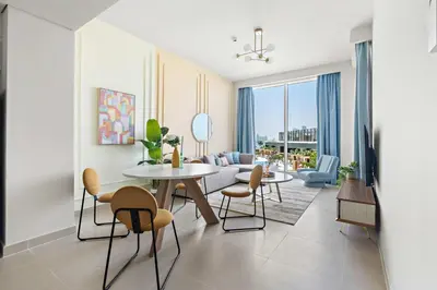 a living room with a table and chairs at Silkhaus brand new 1BDR in Creek Harbour in Dubai
